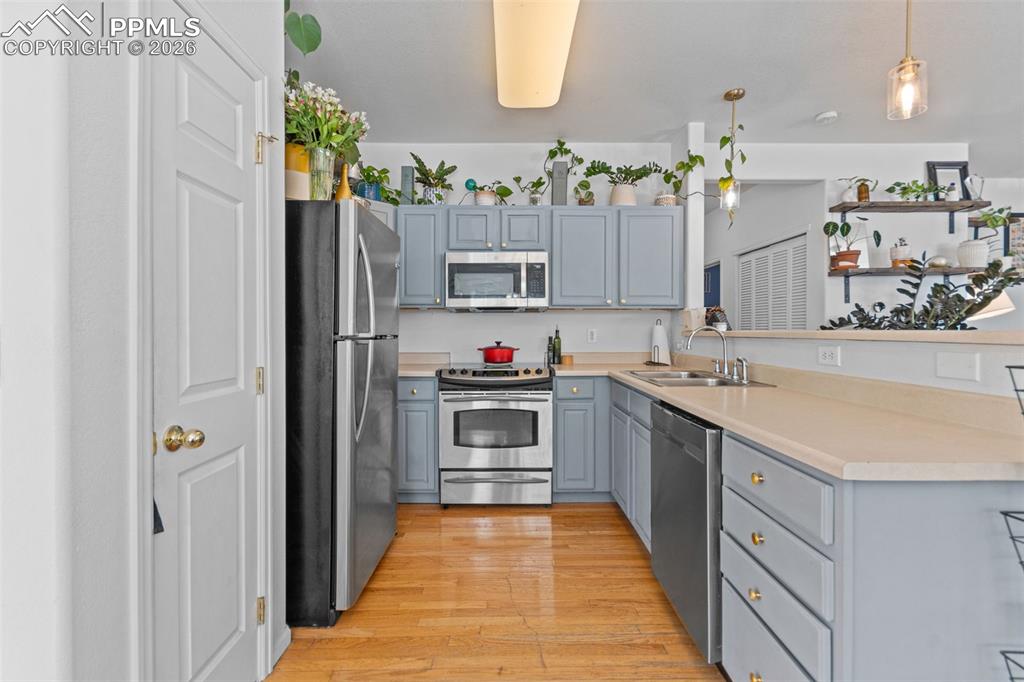 1563 Monterey Road, Unit B Colorado Springs, CO 80910 - Photo 9 of 27 a large kitchen with stainless steel appliances granite countertop a stove and a sink