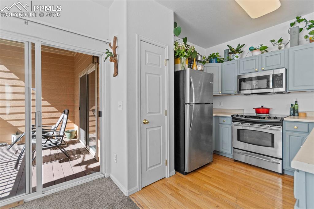 1563 Monterey Road, Unit B Colorado Springs, CO 80910 - Photo 10 of 27 a kitchen with stainless steel appliances kitchen island granite countertop a refrigerator and a stove