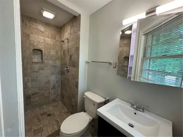 a bathroom with a sink toilet and shower