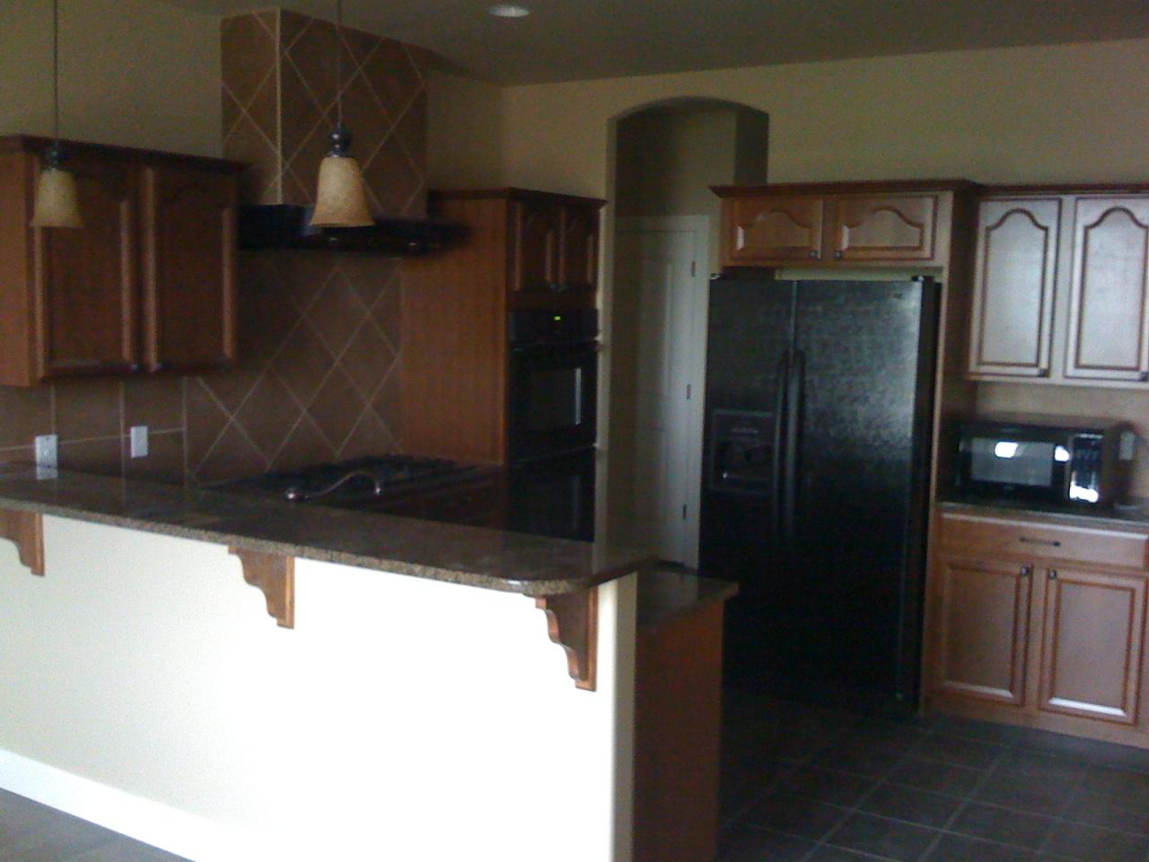 2350 Cook Road Yakima, WA 98908 - Photo 7 of 13 a kitchen with a refrigerator and cabinets