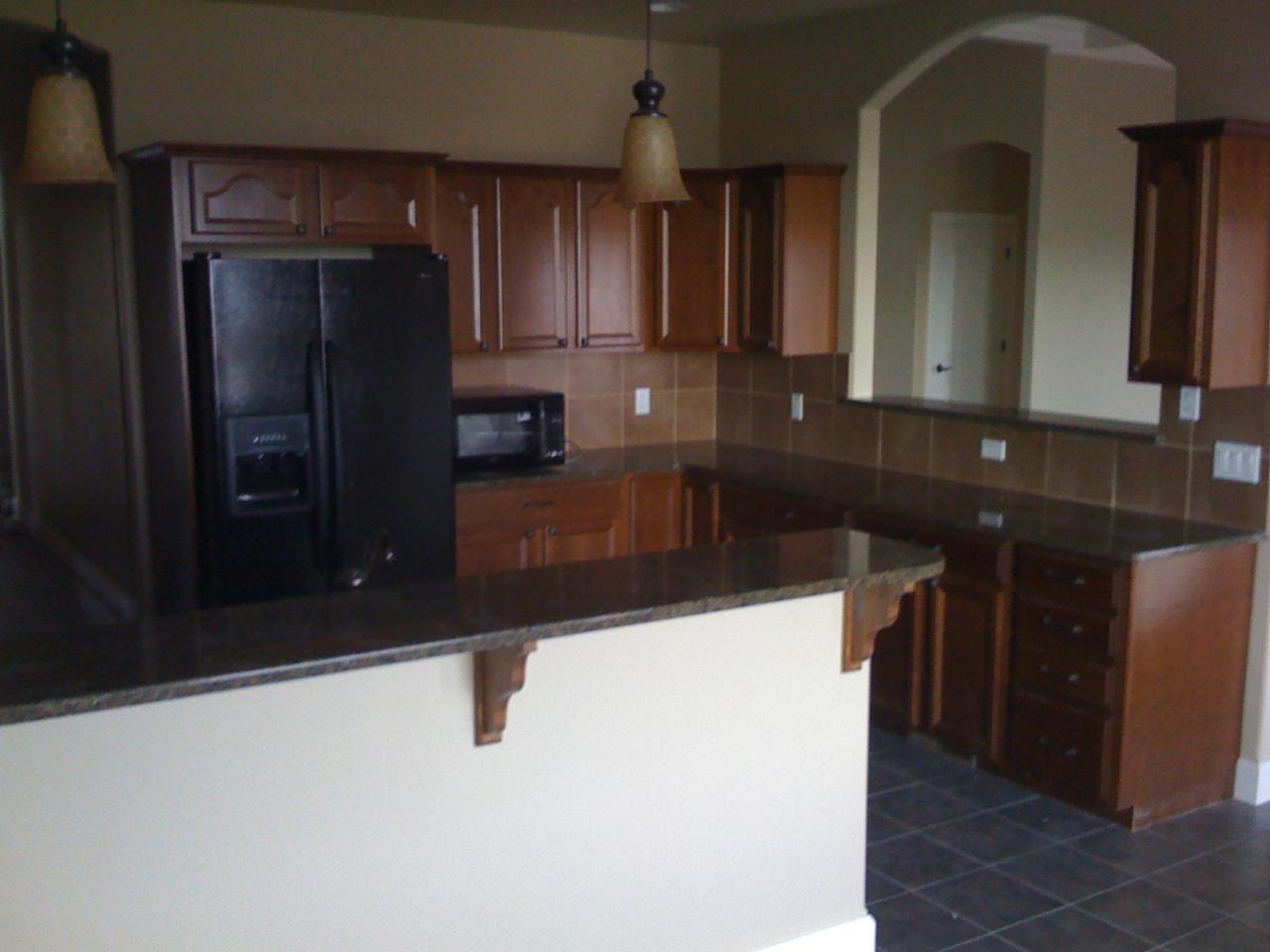 2350 Cook Road Yakima, WA 98908 - Photo 8 of 13 a kitchen with granite countertop a refrigerator and a sink