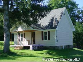 177 Rd Union Dale, PA 18470 - Photo 1 of 3 a front view of a house with a yard