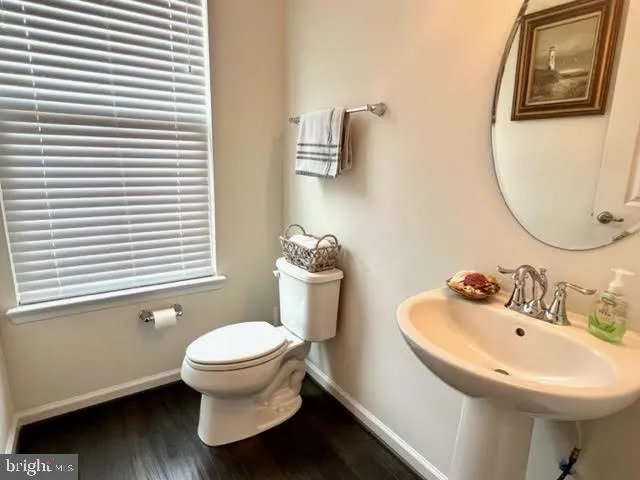 a bathroom with a sink toilet and a mirror