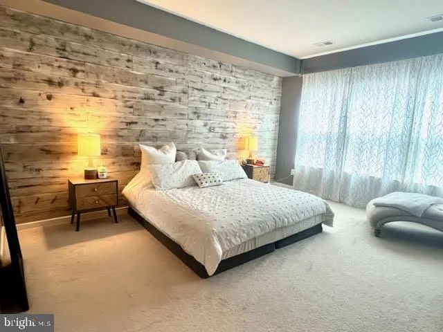 a bedroom with a bed and a couch