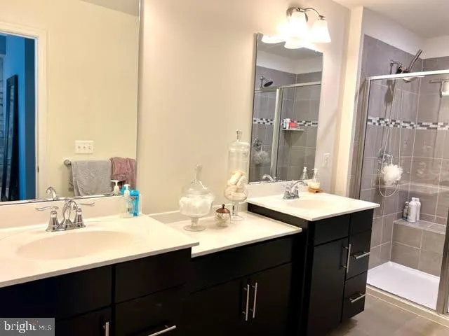 a bathroom with a sink double vanity and a mirror