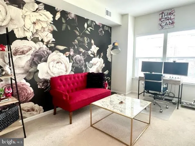 a view of a workspace with furniture and a window