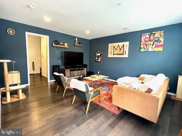 a bedroom with furniture and a wooden floor