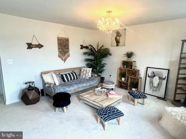 a living room with furniture a rug and a chandelier
