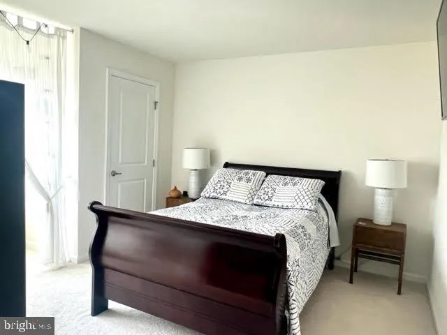 a bedroom with a bed and a lamp