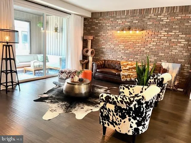 a living room with furniture floor to ceiling window and a table