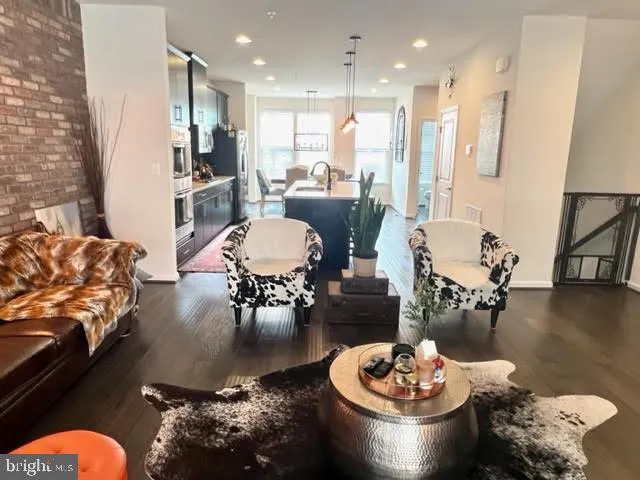 a living room with furniture and a dining table with kitchen view