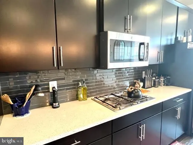 a kitchen with a sink a stove and cabinets