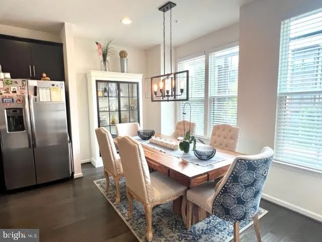 a dining room with furniture a chandelier and window