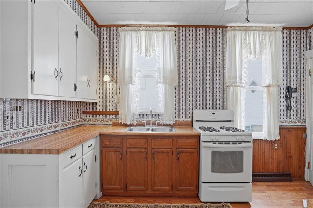 221 Kay Street Wampum, PA 16157 - Photo 16 of 39 a kitchen with stainless steel appliances a sink stove and cabinets