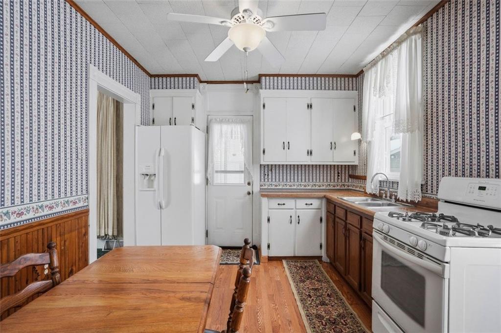 221 Kay Street Wampum, PA 16157 - Photo 18 of 39 a kitchen with stainless steel appliances a stove a sink and a refrigerator