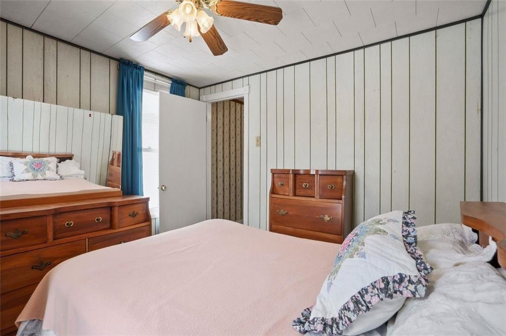 221 Kay Street Wampum, PA 16157 - Photo 23 of 39 a bedroom with a large bed and a chandelier