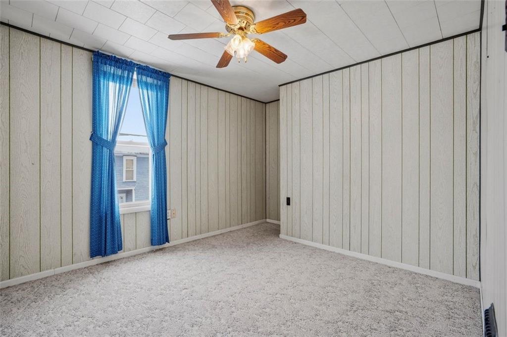 221 Kay Street Wampum, PA 16157 - Photo 24 of 39 an empty room with closet and a chandelier fan