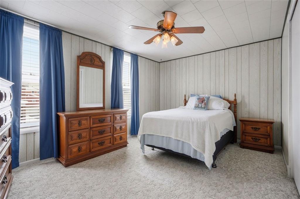 221 Kay Street Wampum, PA 16157 - Photo 27 of 39 a bedroom with a bed and a chandelier