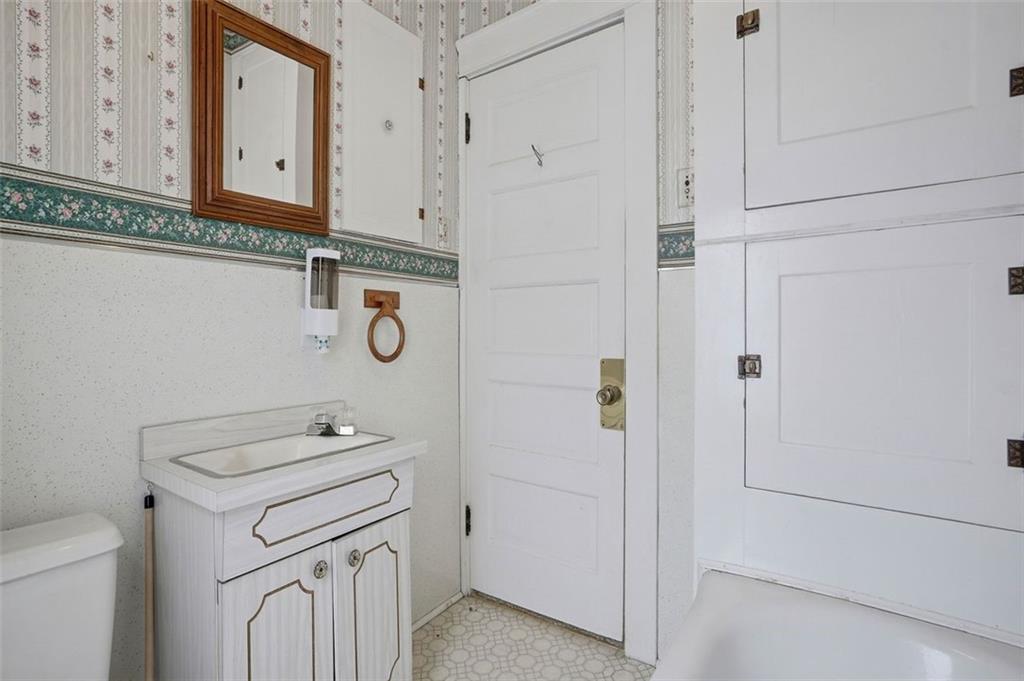 221 Kay Street Wampum, PA 16157 - Photo 30 of 39 a bathroom with a granite countertop toilet and a sink