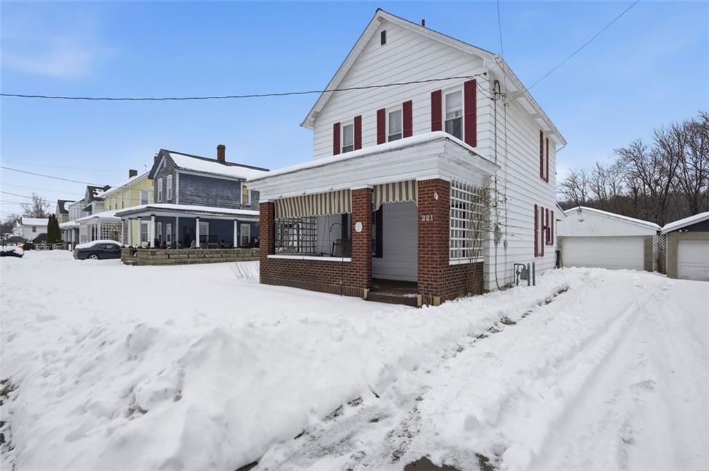 221 Kay Street Wampum, PA 16157 - Photo 4 of 39 a front view of a house with a yard covered in snow