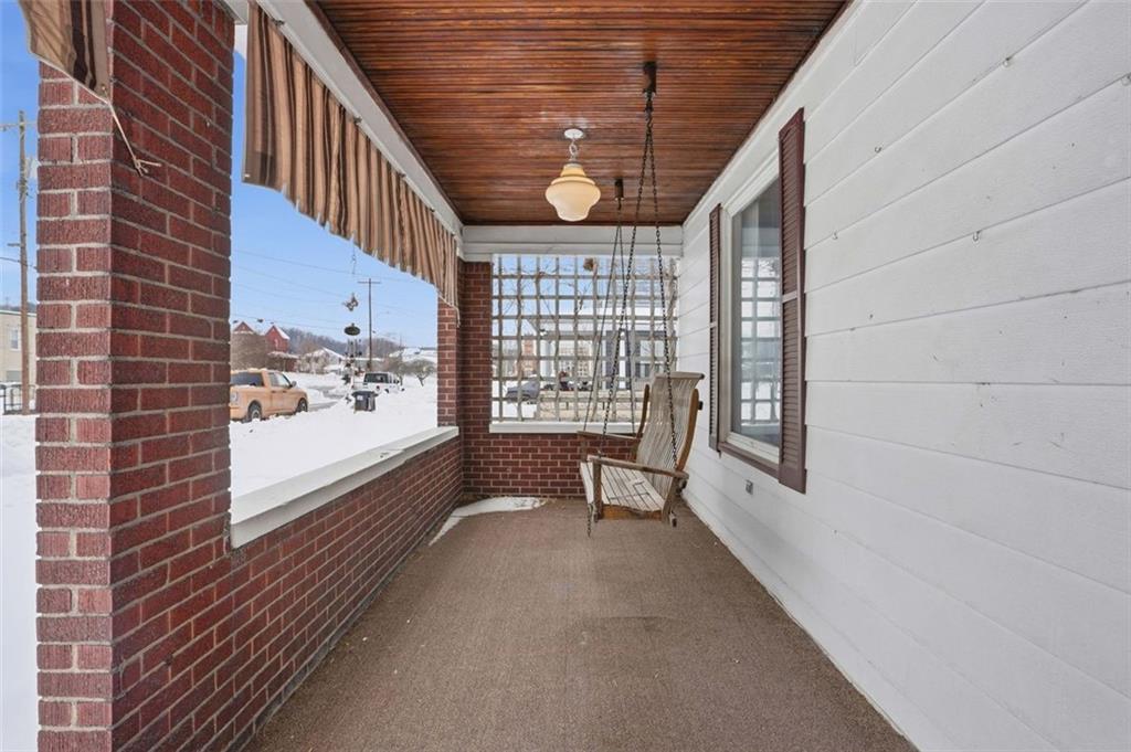 221 Kay Street Wampum, PA 16157 - Photo 5 of 39 a view of a balcony with wooden floor and furniture