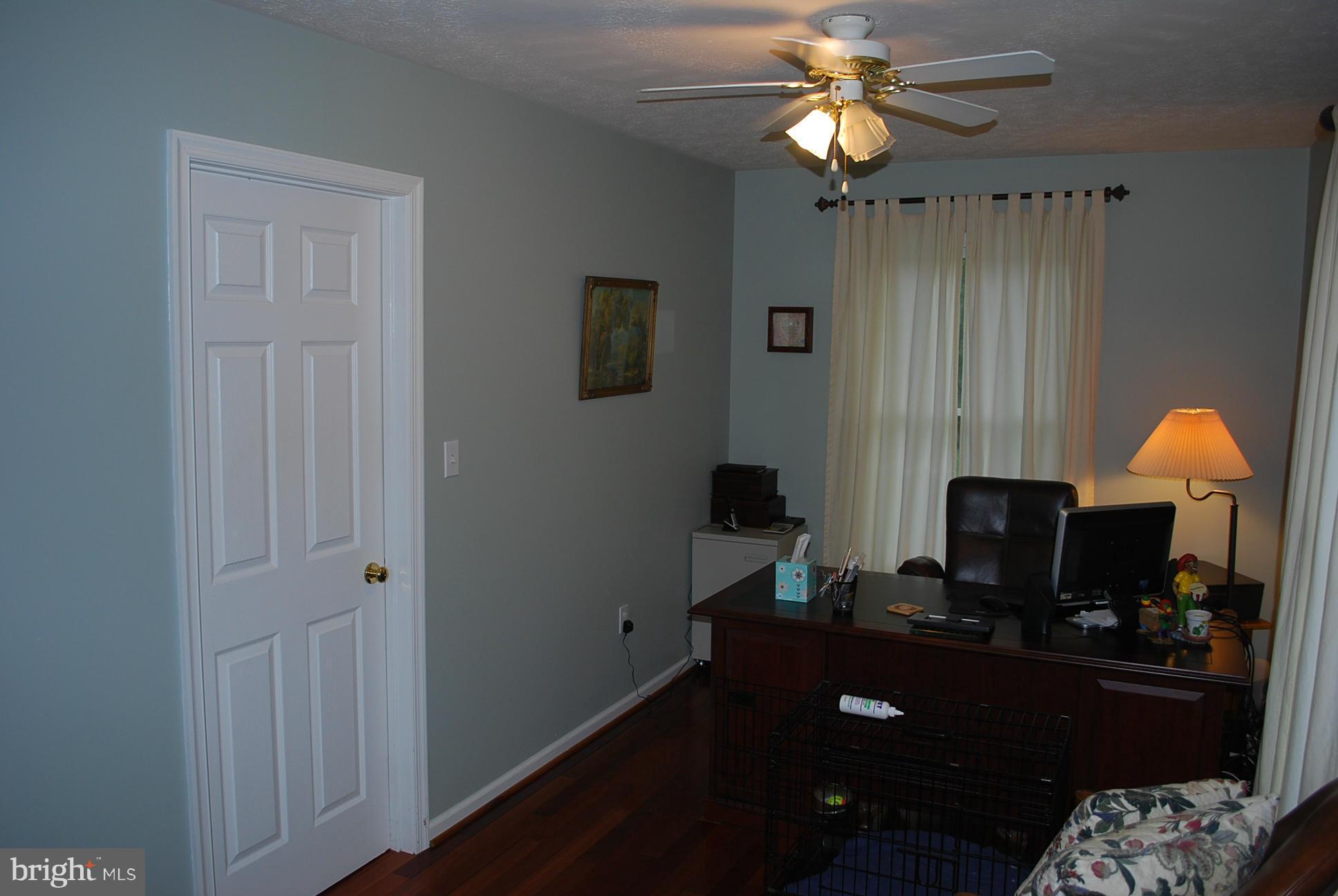 82 Resettlement Road Huntly, VA 22640 - Photo 14 of 21 a room with a chandelier fan and a wooden floor