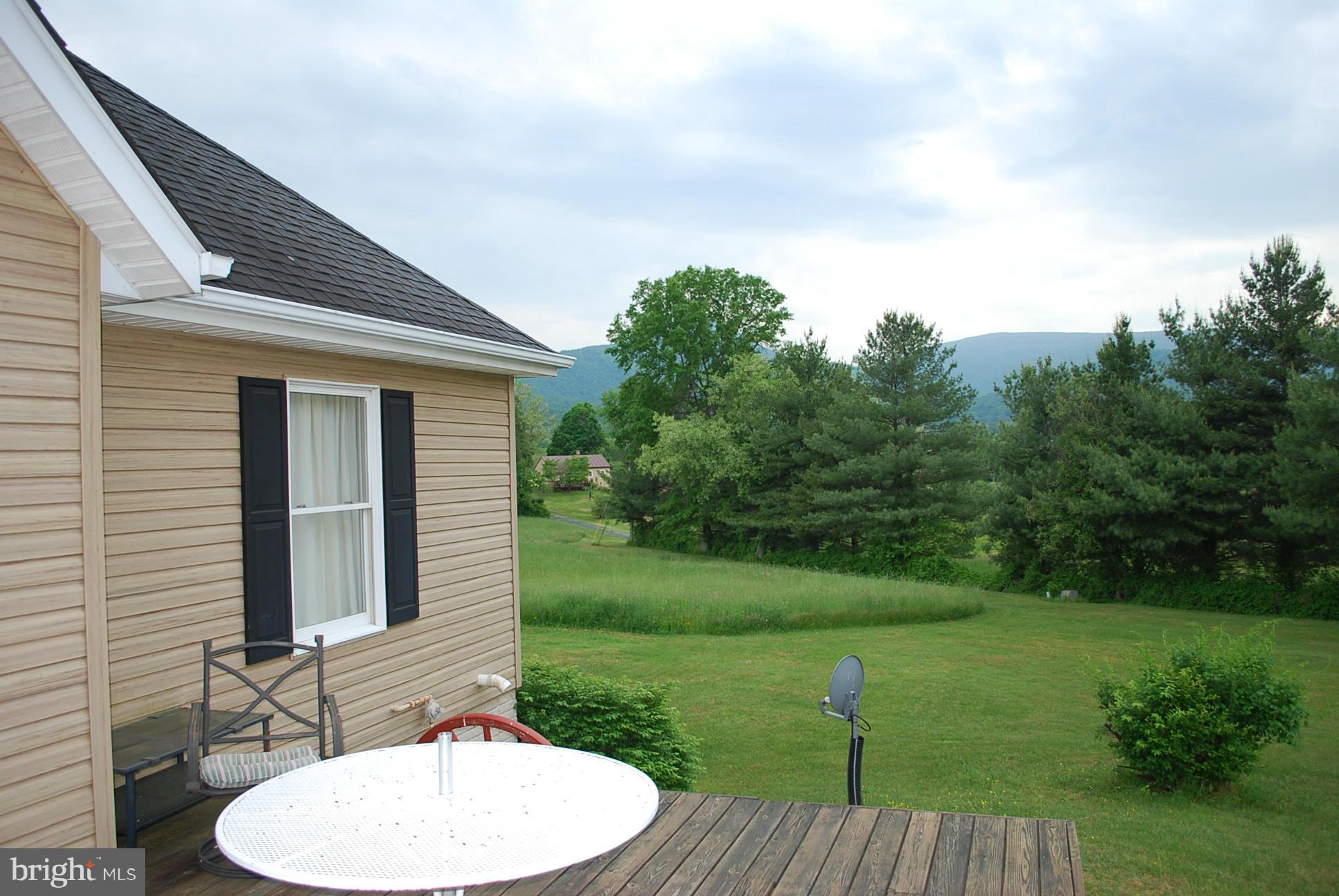 82 Resettlement Road Huntly, VA 22640 - Photo 3 of 21 a backyard of a house with table and chairs