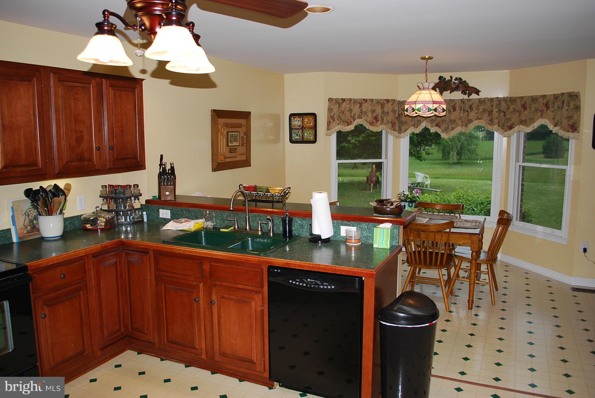 82 Resettlement Road Huntly, VA 22640 - Photo 8 of 21 a kitchen with stainless steel appliances a table and chairs in it