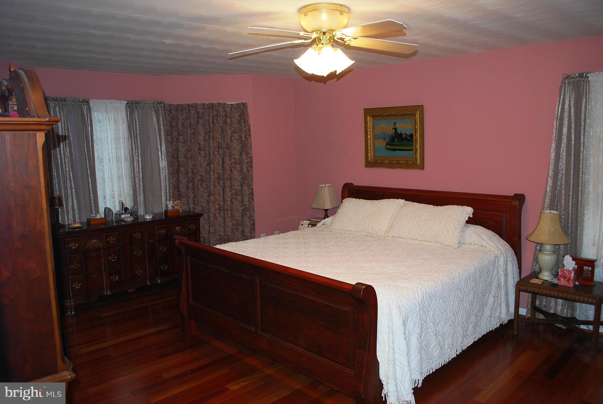 82 Resettlement Road Huntly, VA 22640 - Photo 10 of 21 a bedroom with a bed and a chandelier