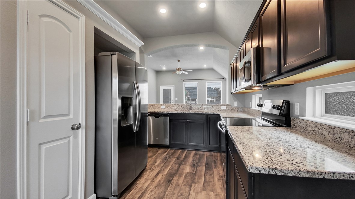 2106 Stubbs Drive Bryan, TX 77807 - Photo 2 of 11 a kitchen with stainless steel appliances granite countertop a refrigerator and a sink