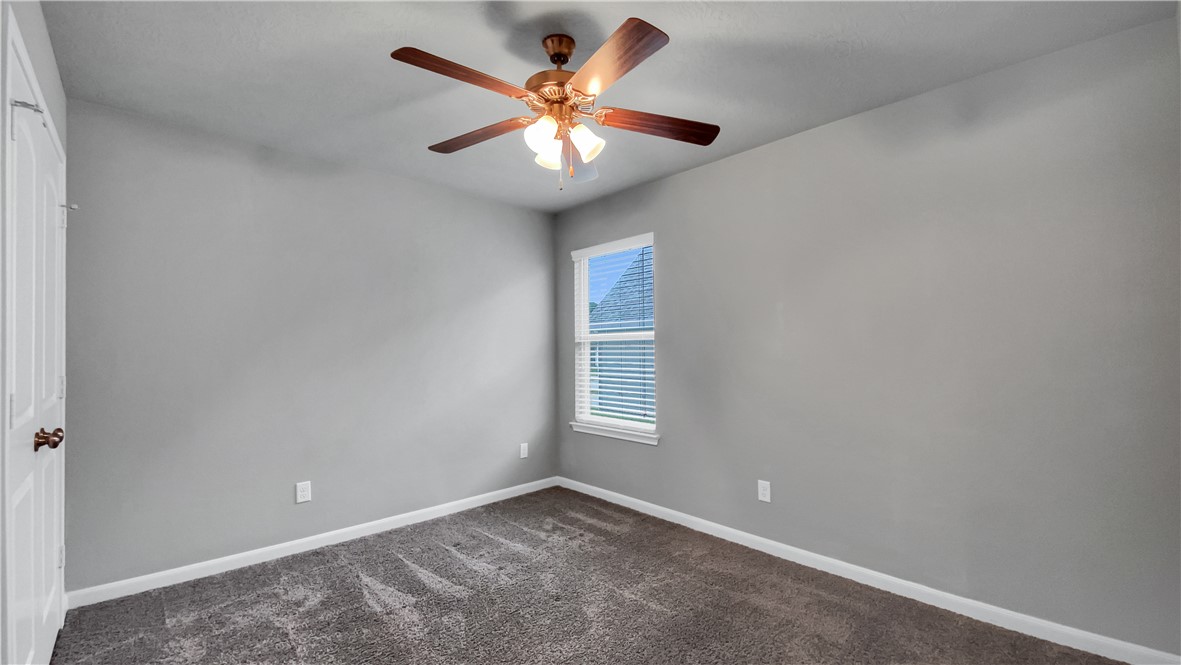 2106 Stubbs Drive Bryan, TX 77807 - Photo 6 of 11 an empty room with windows and fan