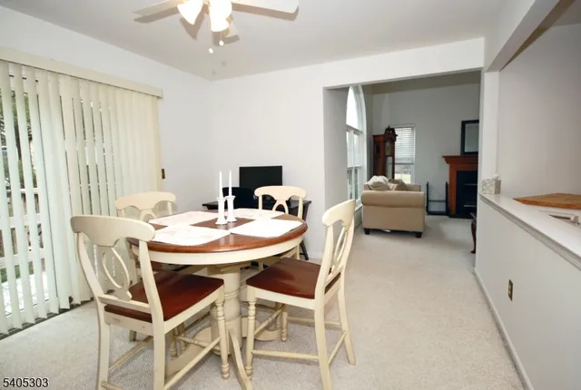 a view of a dining room with furniture and a chandelier