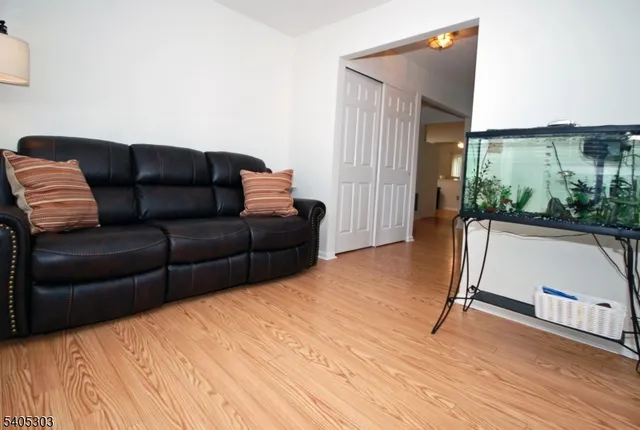 a living room with a couch and a wooden floor