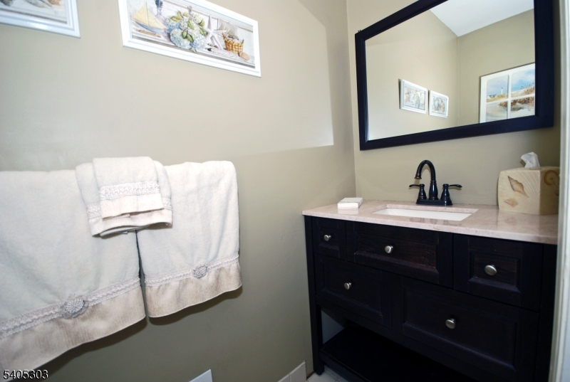 10 Apache Way Somerville, NJ 08876 - Photo 19 of 37 a bathroom with a sink and a mirror