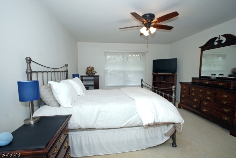 10 Apache Way Somerville, NJ 08876 - Photo 22 of 37 a bedroom with a bed and a flat screen tv