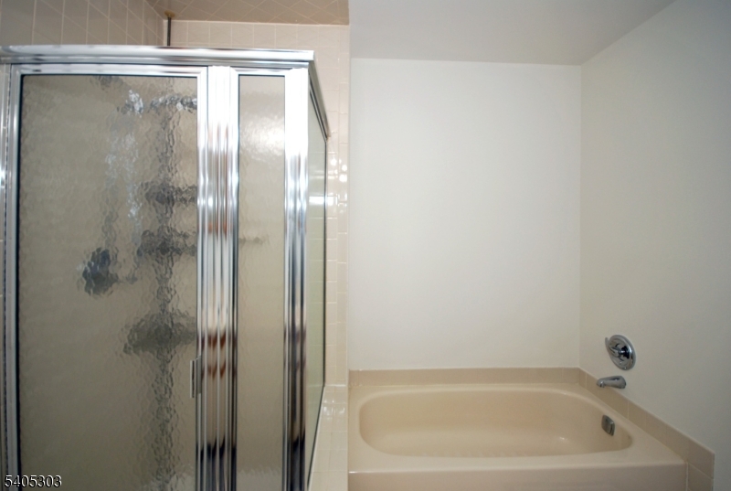10 Apache Way Somerville, NJ 08876 - Photo 26 of 37 a bathroom with a glass shower door
