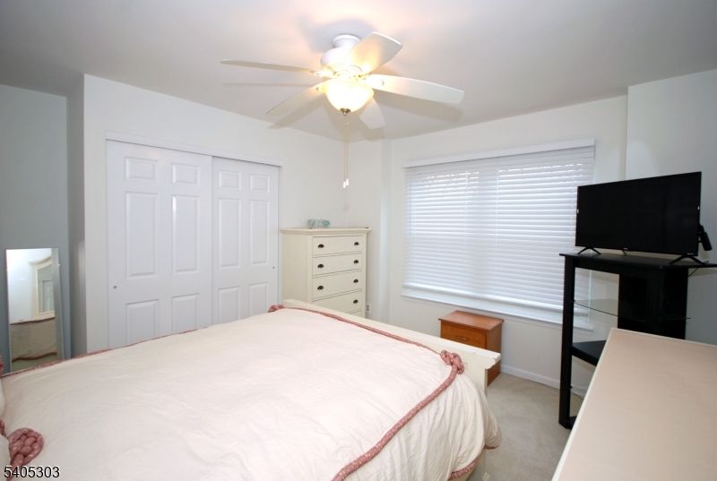10 Apache Way Somerville, NJ 08876 - Photo 29 of 37 a bedroom with a bed and a flat screen tv
