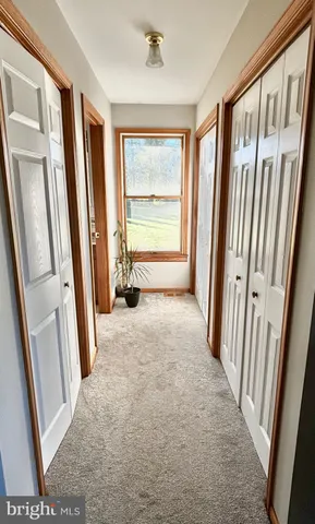 a room with lots of furniture and a book shelf