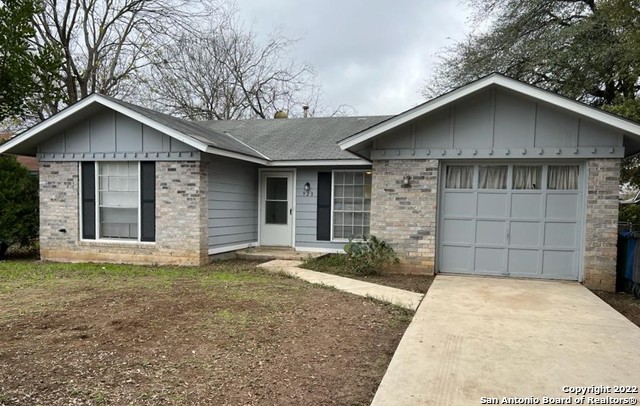 front view of a house with a yard and garage