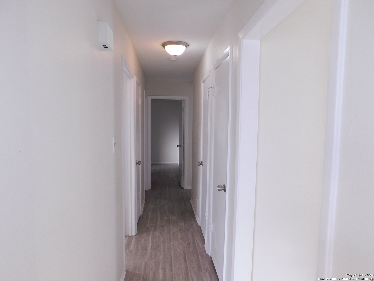 923 Spring Park Drive San Antonio, TX 78227 - Photo 25 of 30 a view of a hallway with a wooden floor