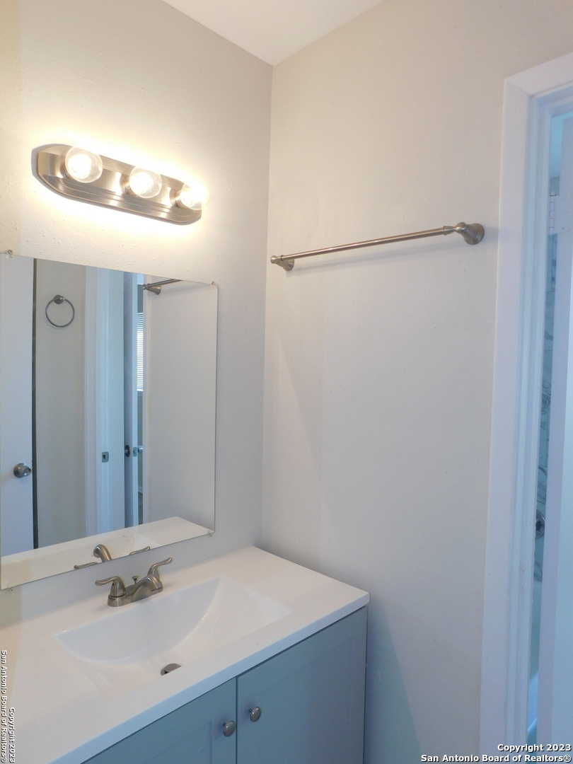 923 Spring Park Drive San Antonio, TX 78227 - Photo 28 of 30 a bathroom with a sink and a mirror