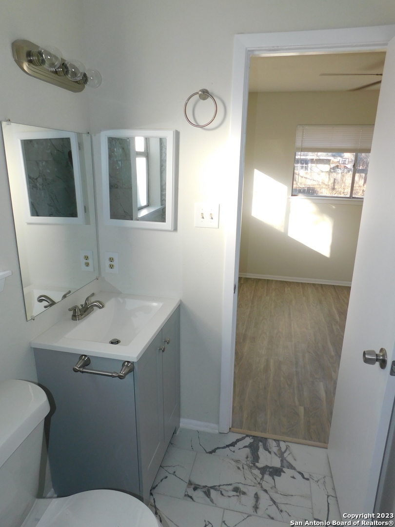 923 Spring Park Drive San Antonio, TX 78227 - Photo 29 of 30 a bathroom with a sink toilet and mirror