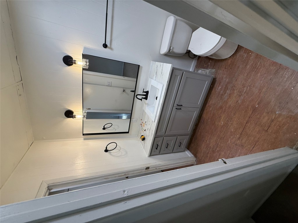 2103 Dixie Lane Round Rock, TX 78664 - Photo 3 of 8 a bathroom with a sink a toilet and mirror