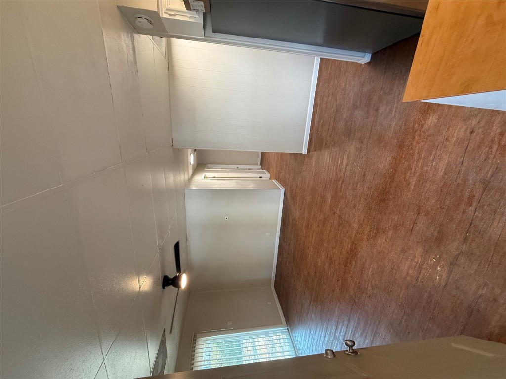 2103 Dixie Lane Round Rock, TX 78664 - Photo 4 of 8 an empty room with wooden floor and windows