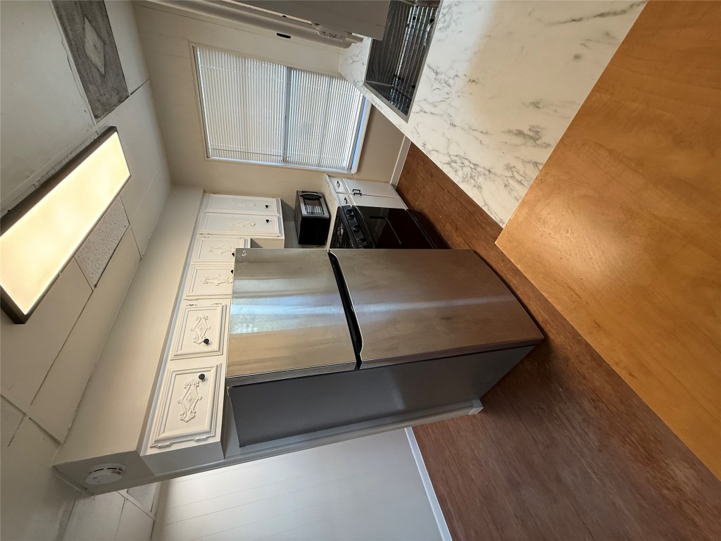 2103 Dixie Lane Round Rock, TX 78664 - Photo 5 of 8 a kitchen with a refrigerator and a stove