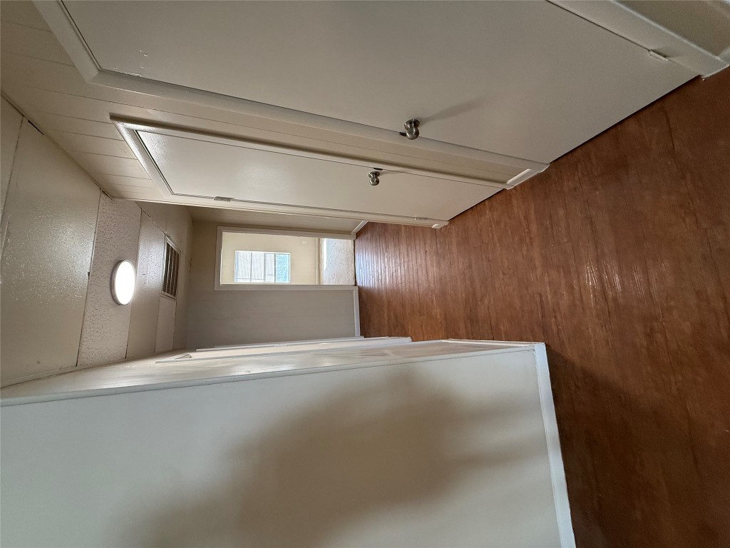 2103 Dixie Lane Round Rock, TX 78664 - Photo 7 of 8 an entryway in a hall with wooden floor and a cabinet