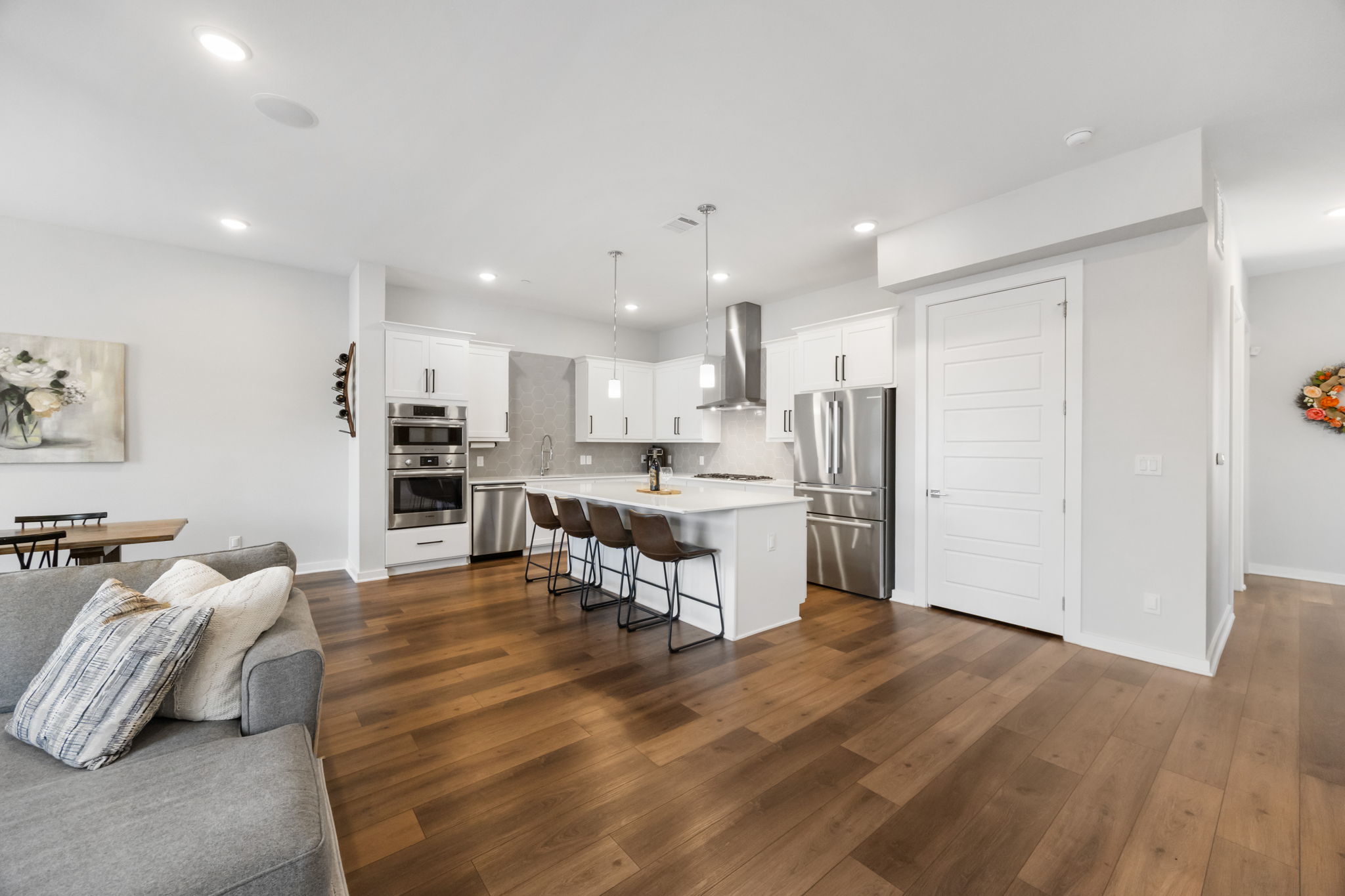 1417 Kramer Lane, Unit 14 Austin, TX 78758 - Photo 31 of 33 Kitchen with open floor plan, a breakfast bar, white cabinetry, and stainless steel appliances