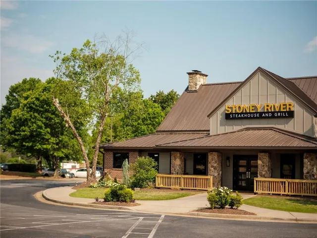 a bunch of flowers in front of a house