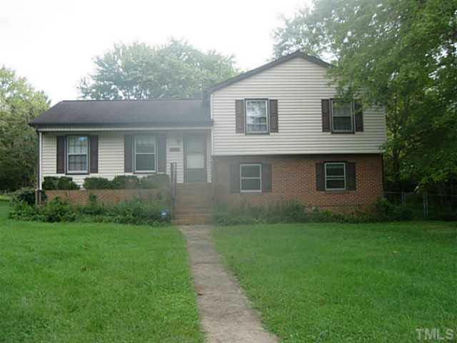 a view of backyard of house with green space
