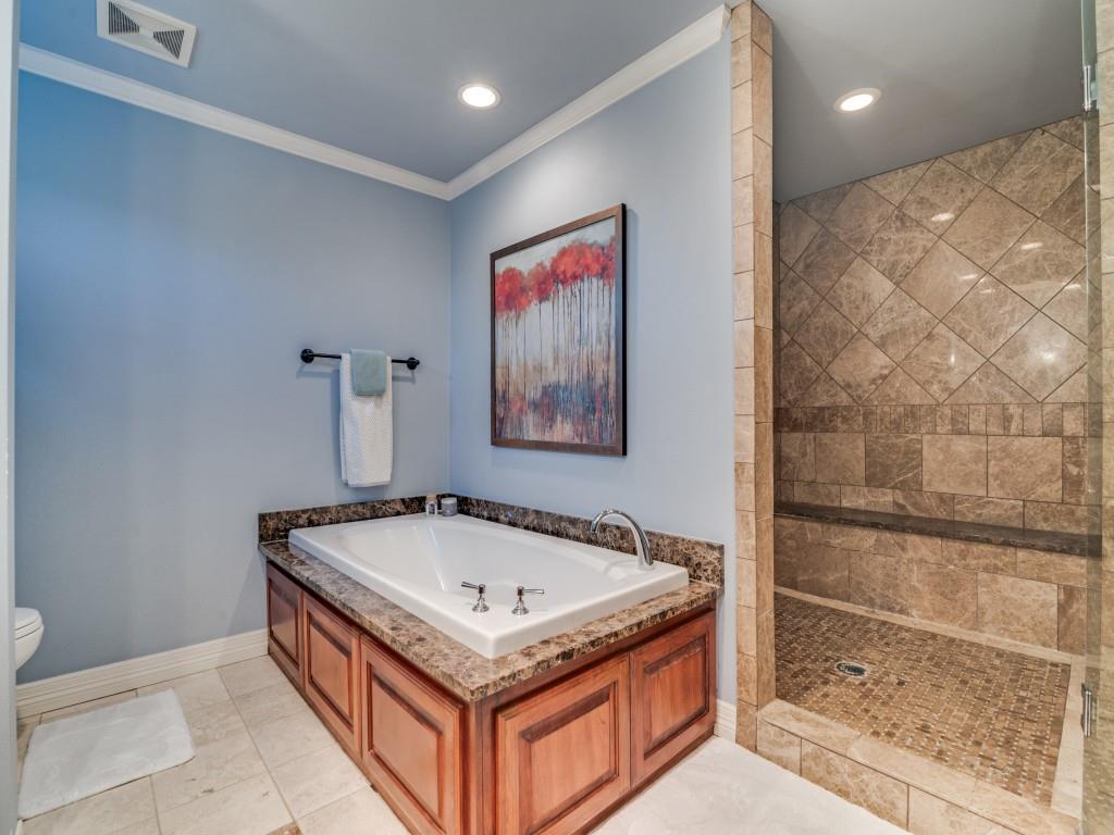 343 East Tripp Road Sunnyvale, TX 75182 - Photo 19 of 36 a bathroom with a tub and a shower